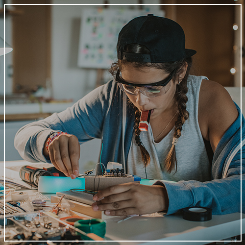 Teenage student working on an technology assignment in a laboratory